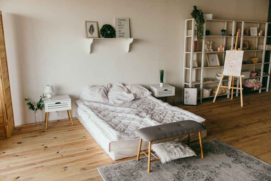 white wooden shelf beside bed